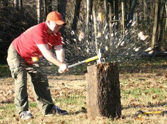 Picture of man smashing a grapefruit with a sledge hammer